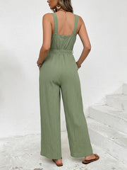 Green crinkled texture tie waist wide leg maternity jumpsuit with square neckline and wide straps.