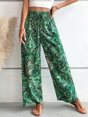 Paisley palazzo trousers in dark green with a drawstring waist and wide legs.