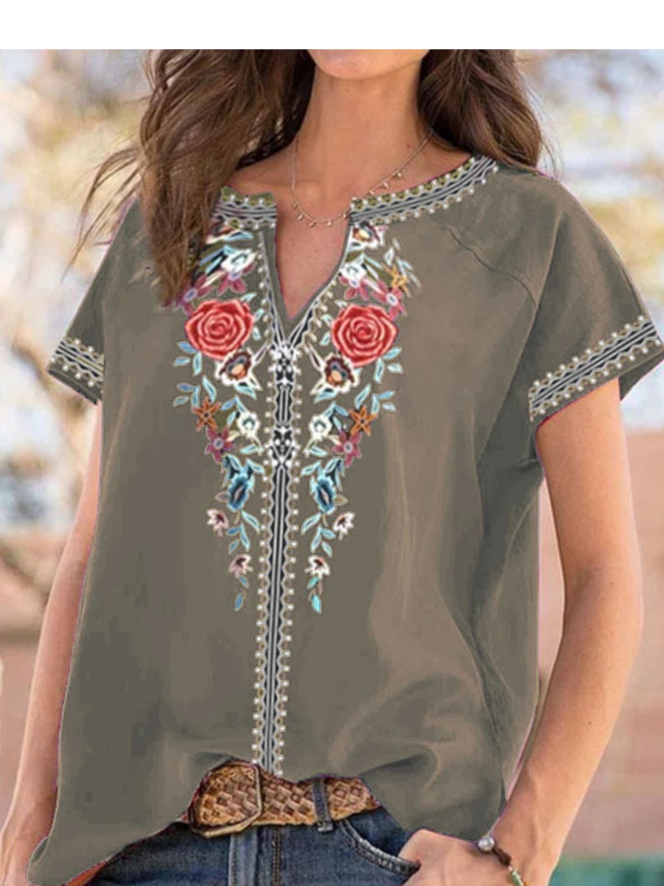 Army green blouse with floral embroidery and notched neckline.