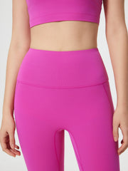 Fuchsia pink high-waisted contour leggings with a seamless waistband and subtle pocket detail.