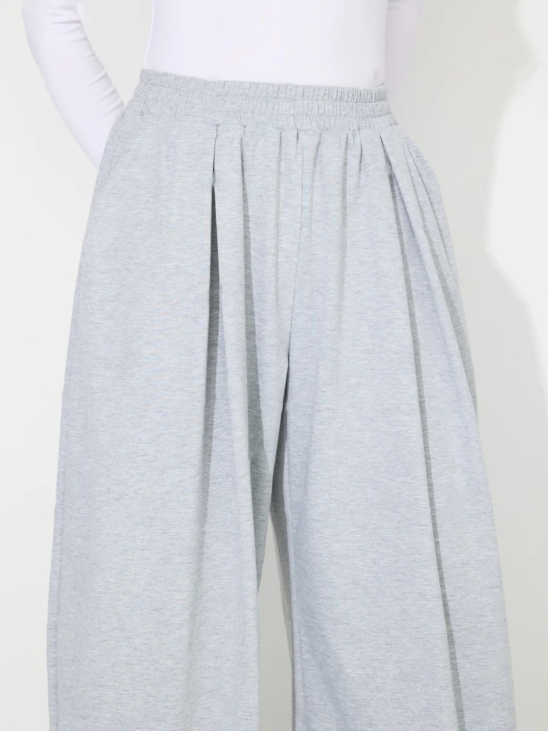 Light gray pleated drape palazzo trousers with elastic waistband and wide leg.