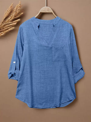 Blue textured maternity shirt with notched V-neck, chest pocket, and roll-tab sleeves.