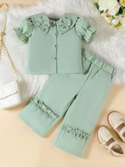 Green toddler set with floral collar, ruffle sleeves, and ruffle hem pants.