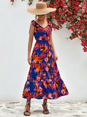 Maxi dress with abstract print, tie straps, and tiered skirt in blue.