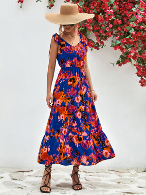 Maxi dress with abstract print, tie straps, and tiered skirt in blue.