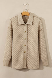 Beige diamond quilted oversized button-up jacket with a collared neckline.