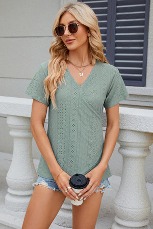 Light green eyelet wrap V-neck top with short sleeves.