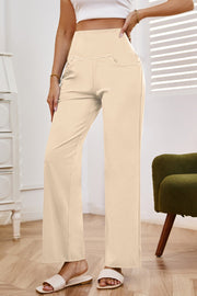 High-waisted flare leg trousers in tan with pockets, styled casually.
