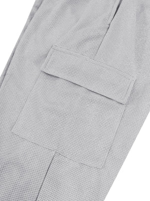 Light gray waffle knit joggers with a flap pocket detail.