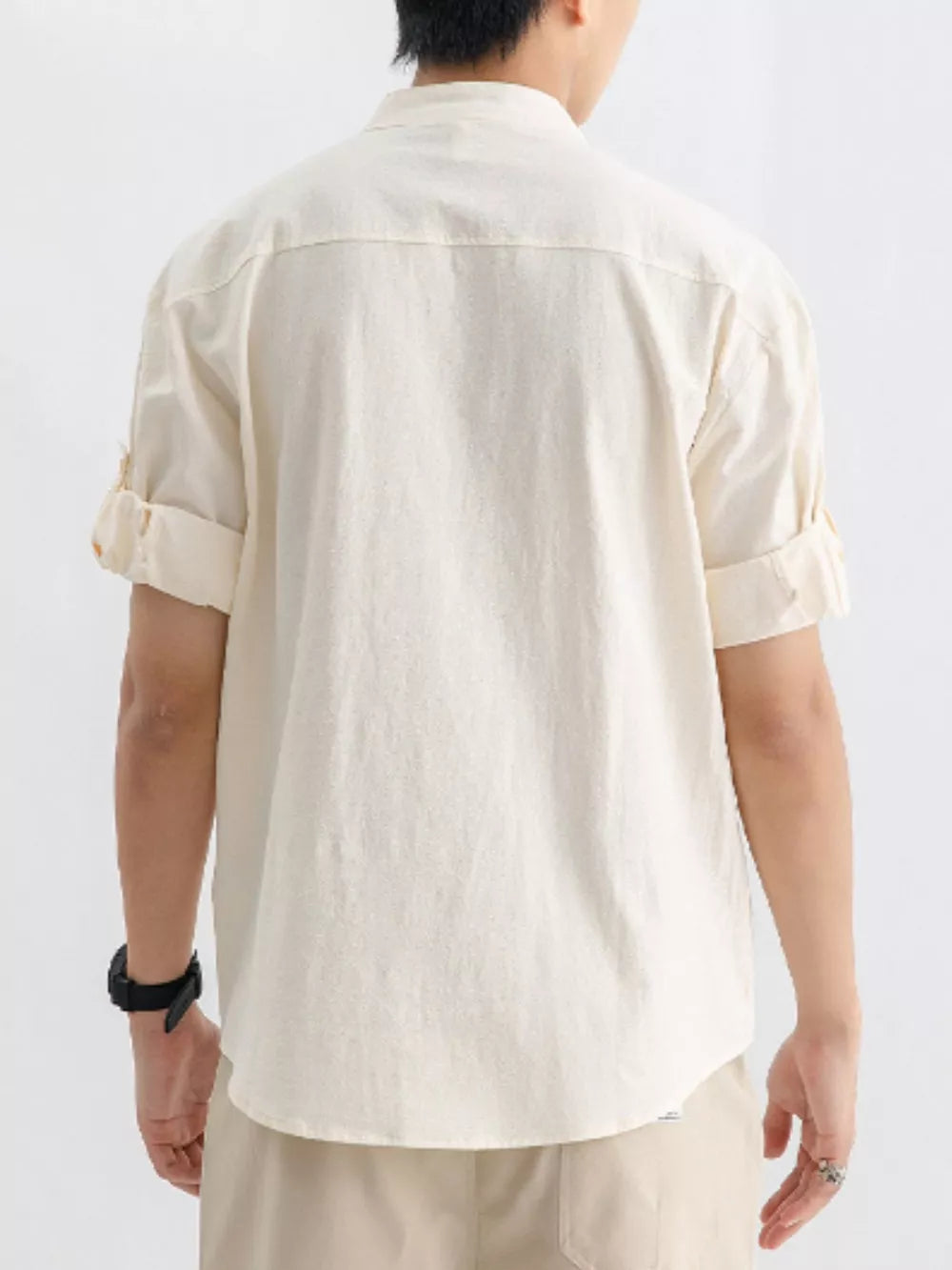 Relaxed fit apricot cotton button-up shirt with rolled short sleeves.