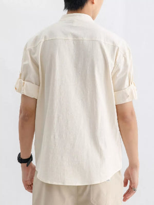 Relaxed fit apricot cotton button-up shirt with rolled short sleeves.