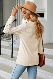 Cream textured henley blouse with button detail and long sleeves