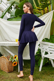 Flounce-hem swimsuit with long sleeves in dark blue, featuring attached leggings and a modest cut.