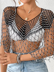 Black crochet cardigan with beaded detail and V-neck, styled over a white top.