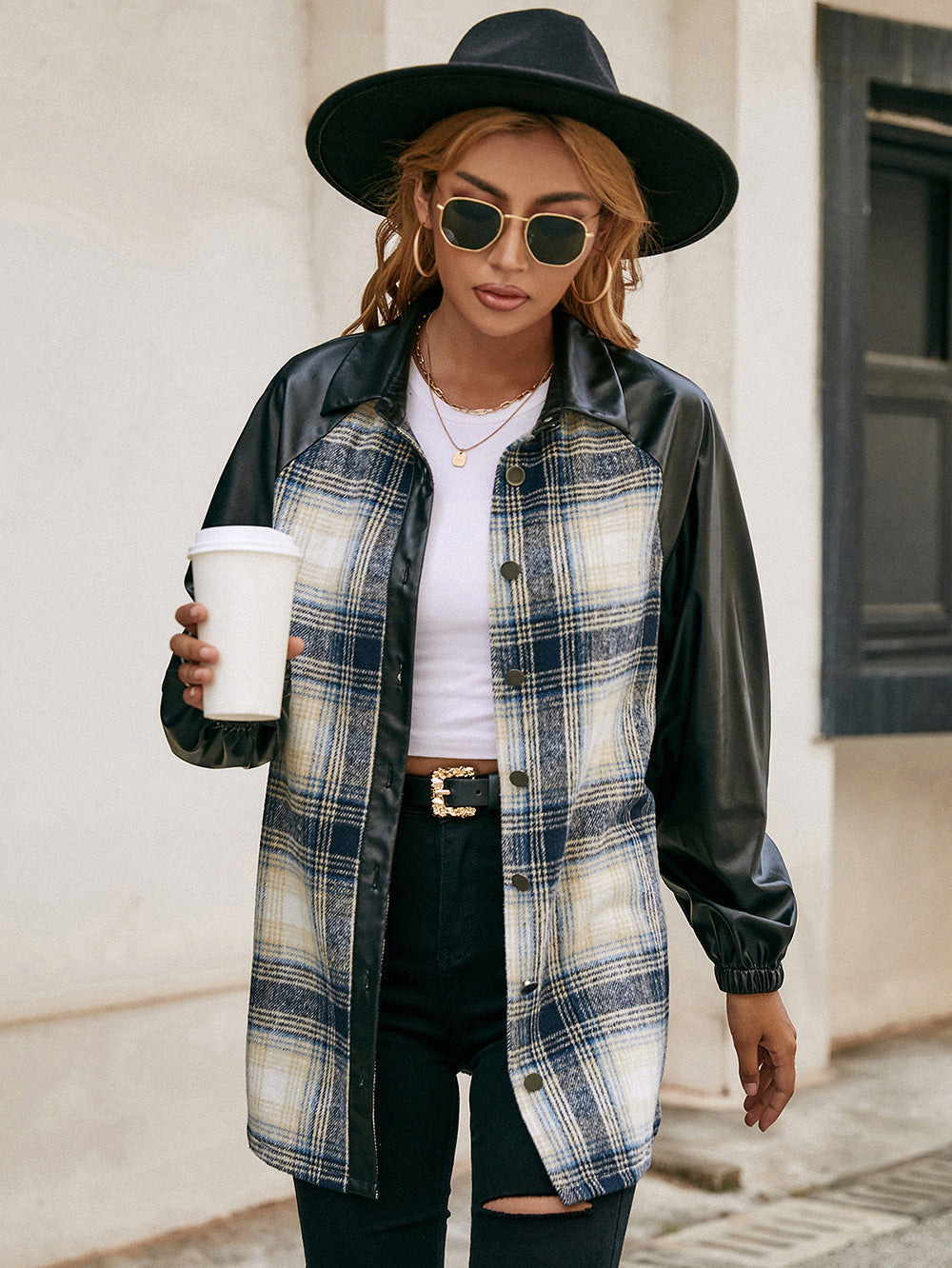 Plaid & faux leather raglan shacket with buttoned front and black sleeves.