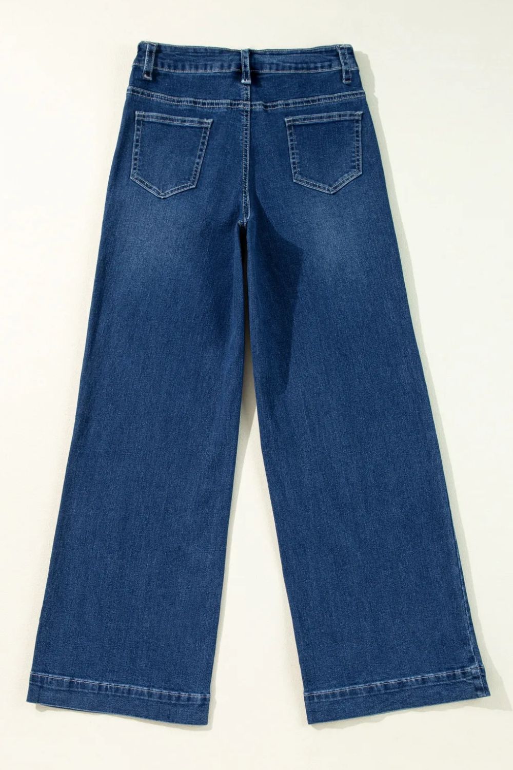 Medium wash denim wide leg jeans with back pockets and buttoned closure.