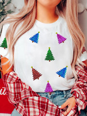 White t-shirt with scattered sequin Christmas trees in blue, green, purple, and red.
