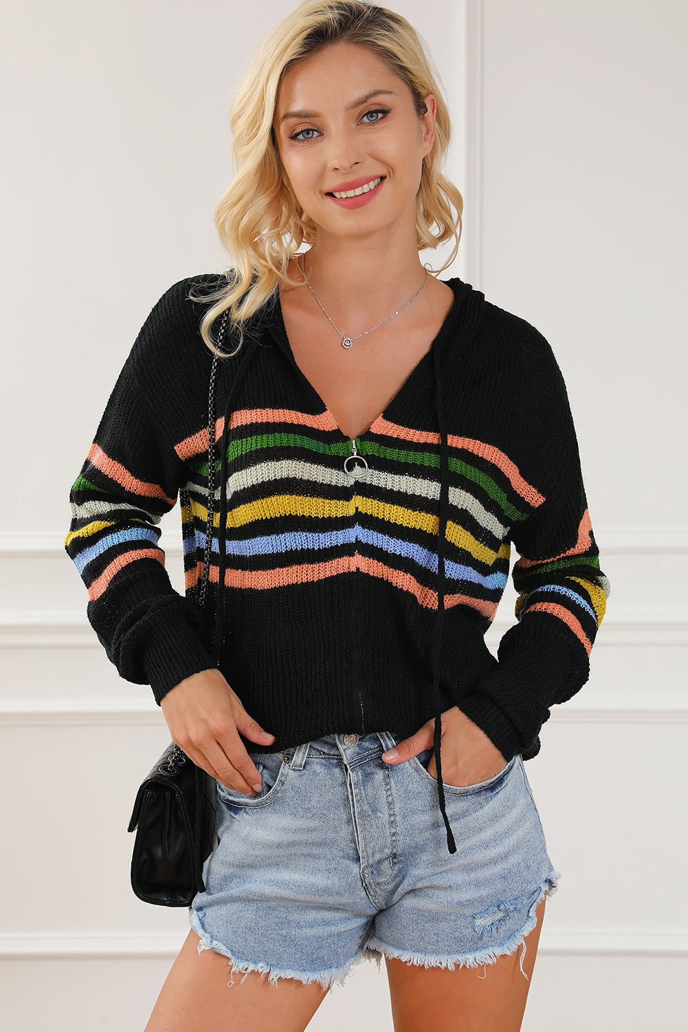 Black knit hoodie with rainbow stripes, zip front, adjustable drawstring hood, and distressed details.