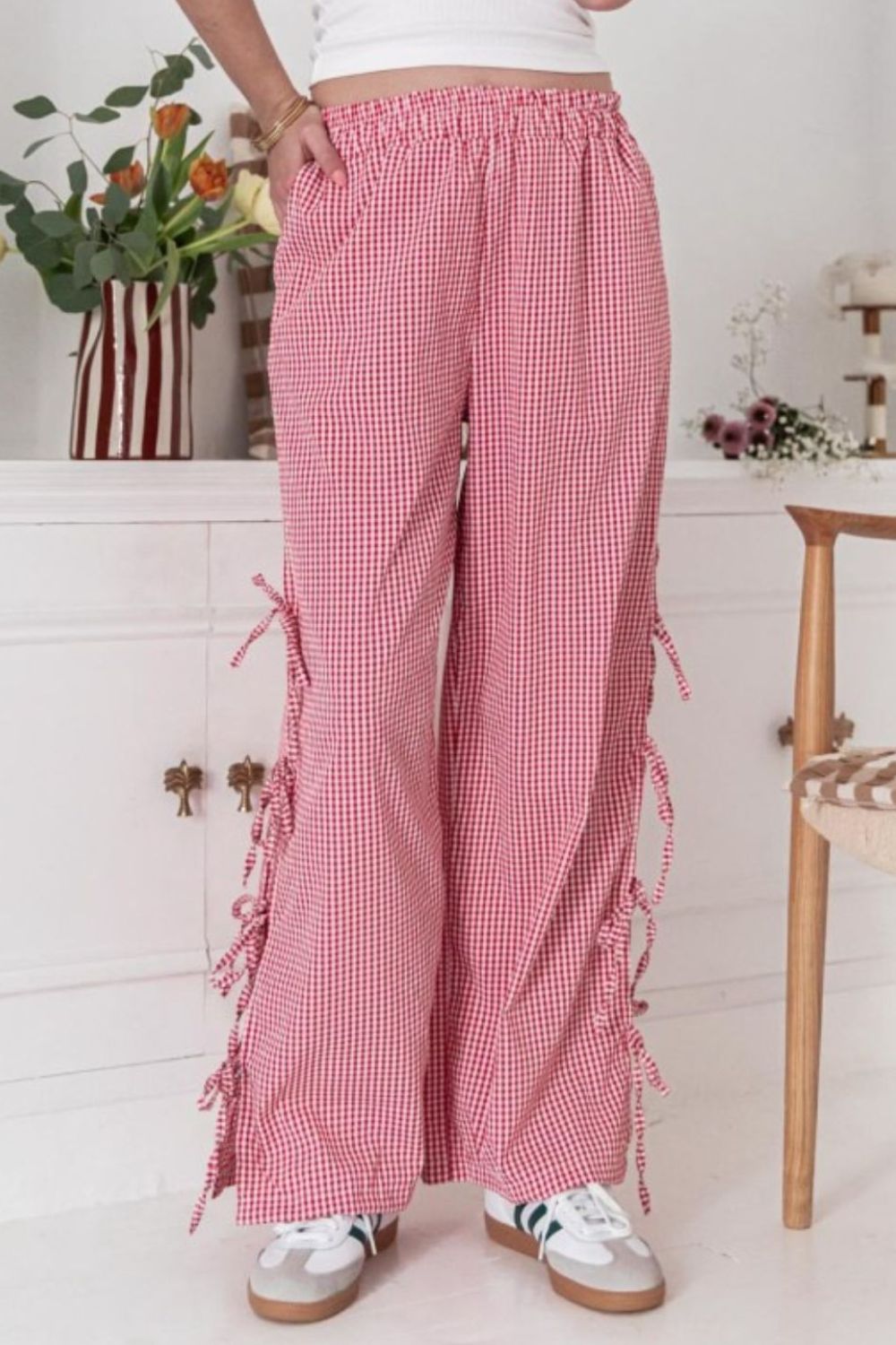 Gingham palazzo trousers in scarlet with side tie details and a wide leg.