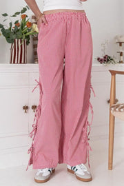 Gingham palazzo trousers in scarlet with side tie details and a wide leg.