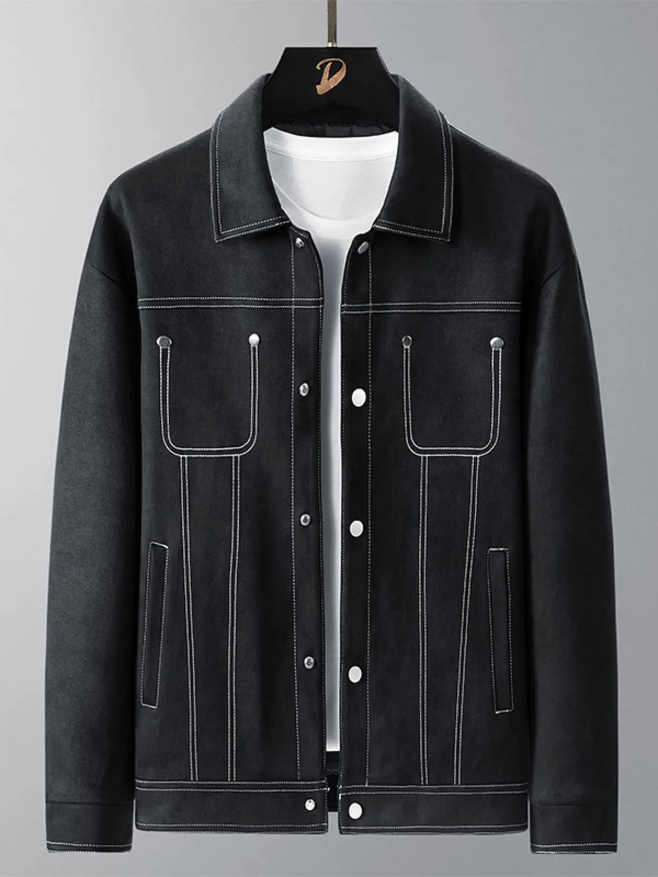 Black trucker jacket with white contrast stitching and snap buttons.