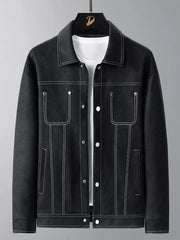 Black trucker jacket with white contrast stitching and snap buttons.