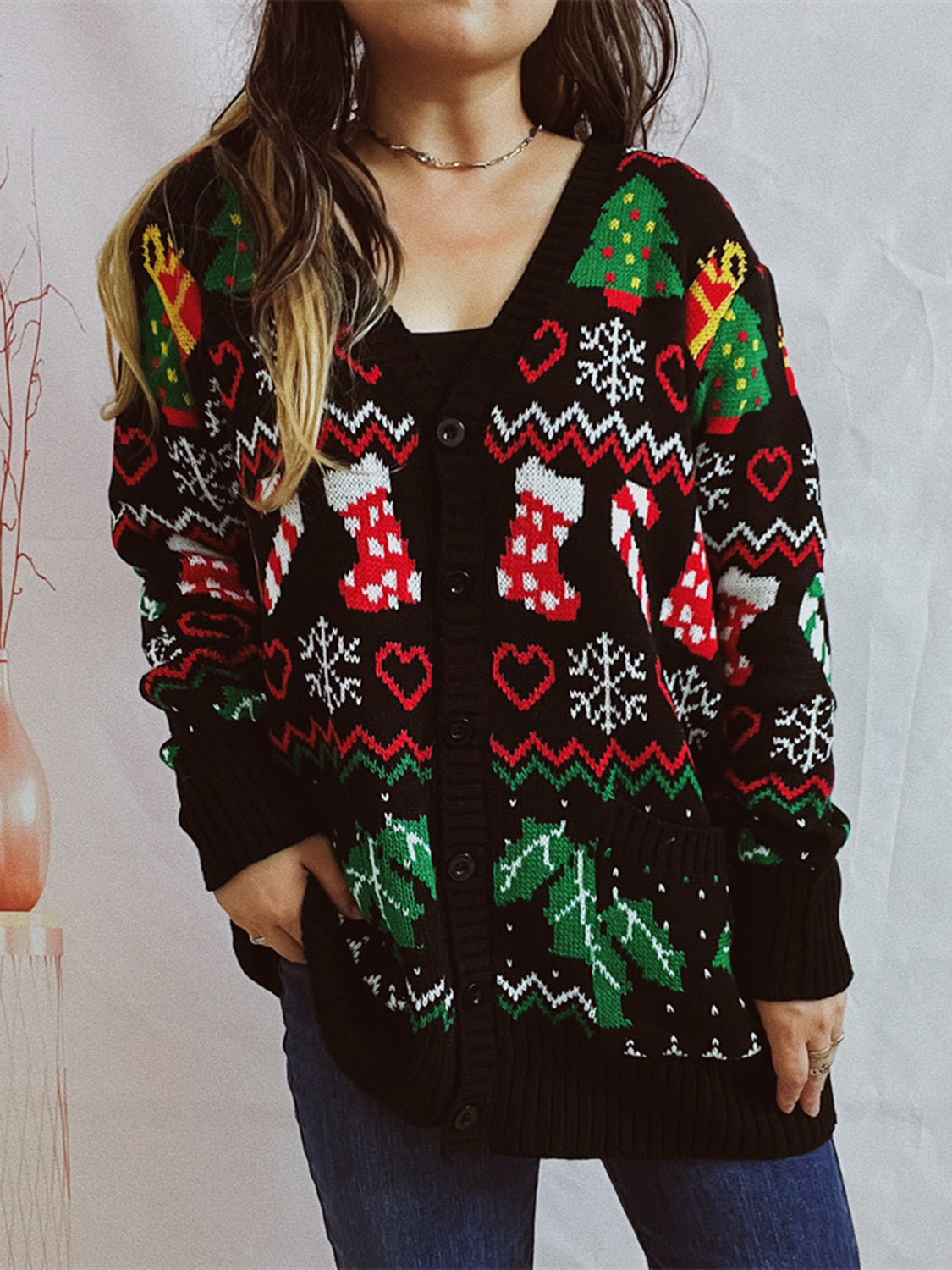 Black acrylic Fair Isle knit cardigan with Christmas motifs, v-neck, button front, pockets.