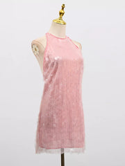 Pink iridescent sequin halter mini dress with sheer overlay and ruffled hem.