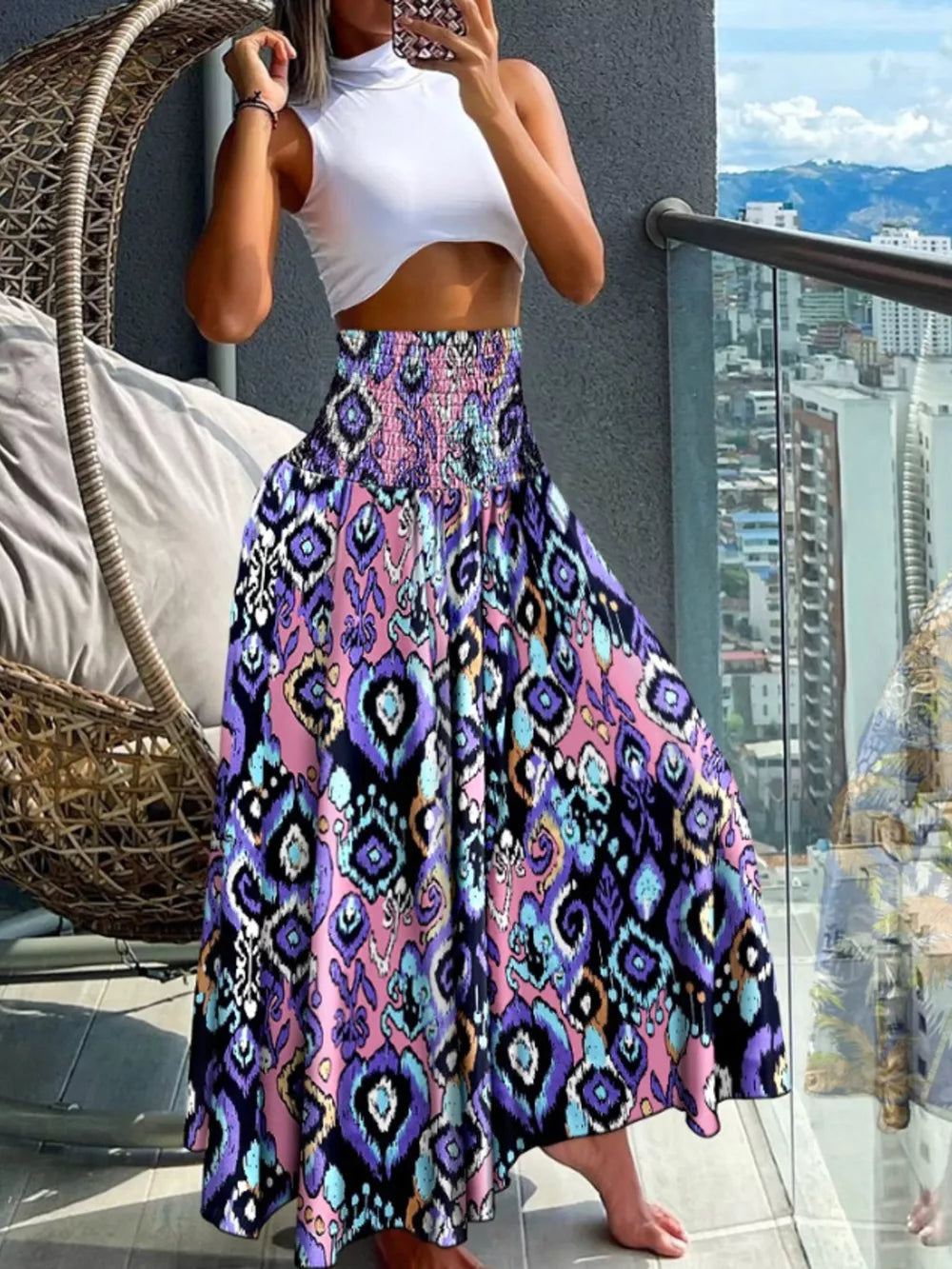 Bohemian print smocked waist maxi skirt with purple, blue, and pink ikat pattern.