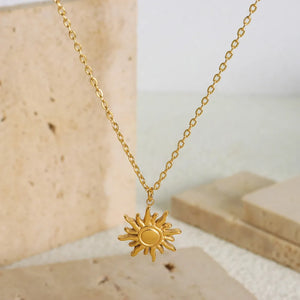 Gold sunburst pendant necklace with adjustable chain, 18K gold-plated.
