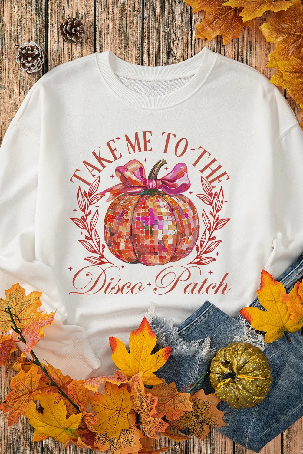White roundneck sweatshirt with a disco ball pumpkin graphic and text.