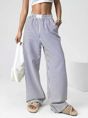 Navy striped high-waisted wide-leg pants with drawstring detail and pockets.
