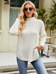 White acrylic turtleneck sweater with diamond knit texture and relaxed fit.