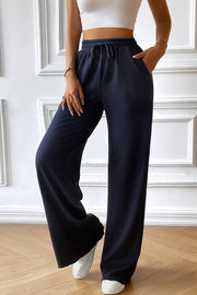 Dark blue textured rib wide-leg drawstring trousers with pockets.