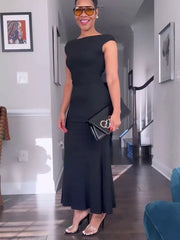 Black backless cap sleeve maxi gown with boat neckline and body-skimming cut.