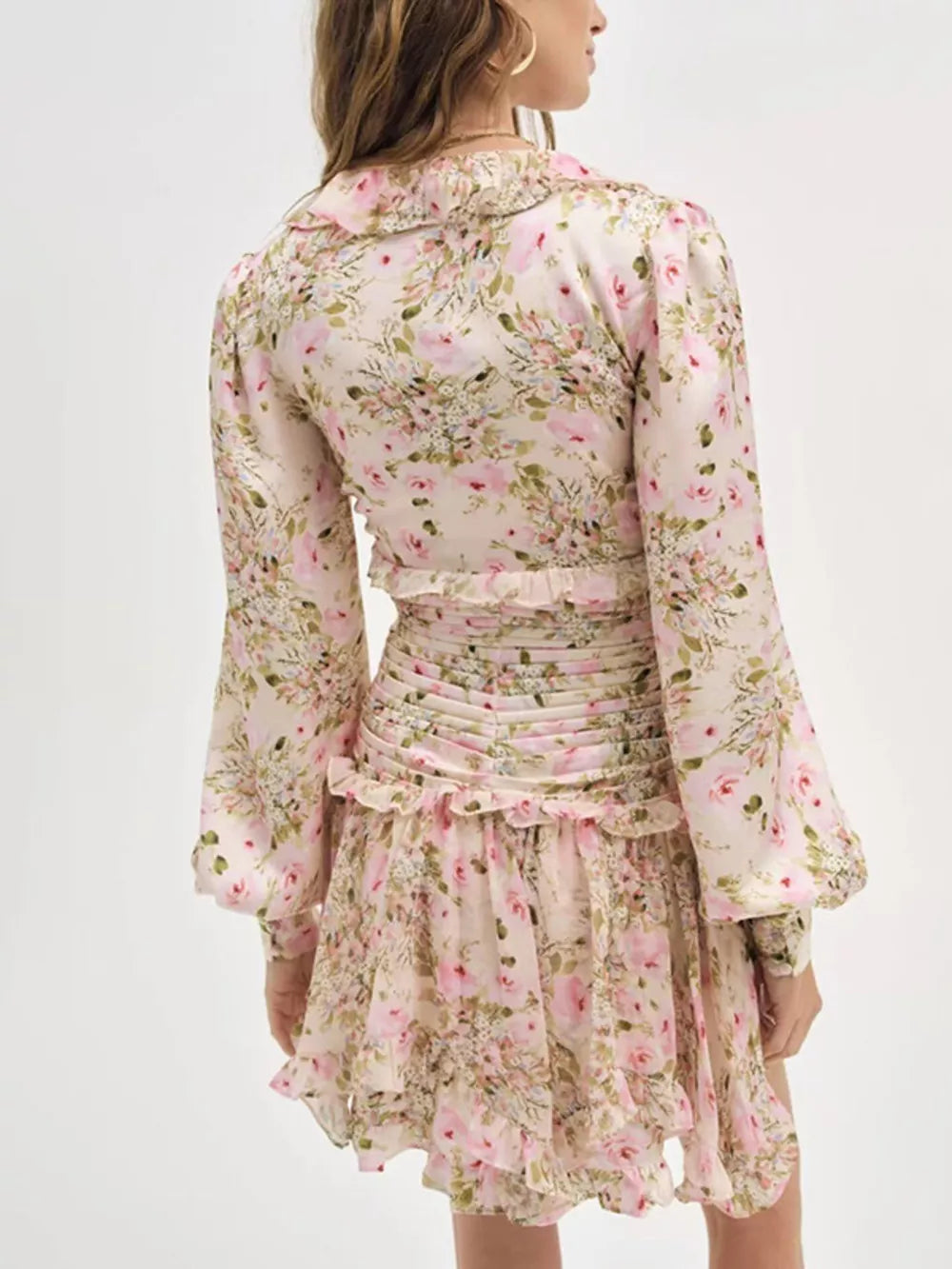 Charming ruffled floral mini dress with ruched waist and bell sleeves.