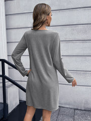 Light gray long sleeve button-down mini dress with A-line cut.