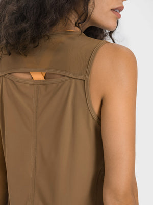 Camel mesh-back performance tank top with cutout detail and orange strap accent.