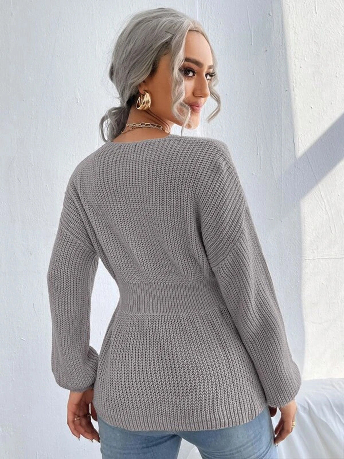 Grey peplum knit sweater with scallop neckline and cinched waist
