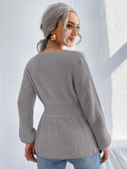 Grey peplum knit sweater with scallop neckline and cinched waist