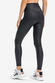 Black textured high-waisted leggings with a V-seam detail at the back.