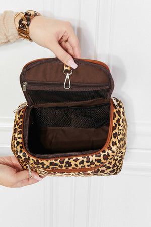 Leopard print travel organizer bag with multiple mesh compartments and zipper closure.