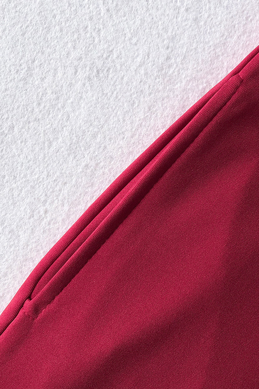 Deep Red belted palazzo jumpsuit detail showing pocket and fabric texture.
