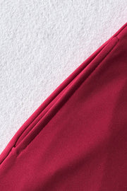Deep Red belted palazzo jumpsuit detail showing pocket and fabric texture.