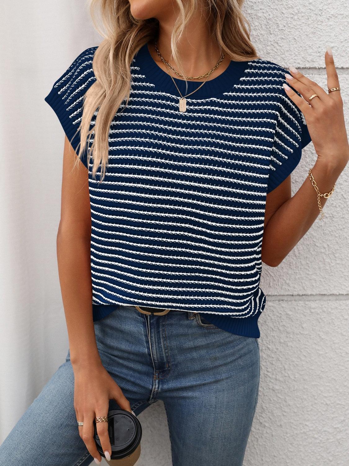 Dark blue and white horizontal stripe knit shell top with cap sleeves.