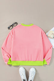 Blush pink sweatshirt with neon green trim and cuffs.