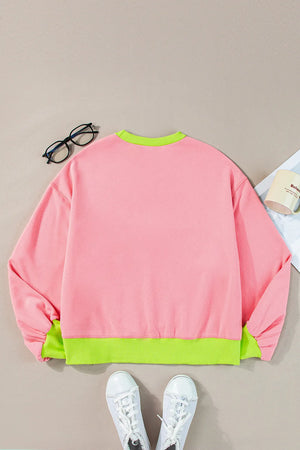 Blush pink sweatshirt with neon green trim and cuffs.