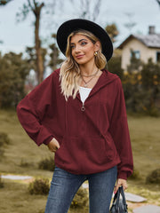 Textured knit dolman sleeve hoodie in wine with zip front and front pocket.