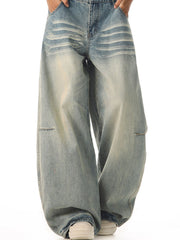 Men's vintage wide leg jeans in light blue cotton with faded details and button fly.