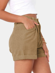 Camel corduroy pleated high-waist shorts with cuffed hem and pockets.